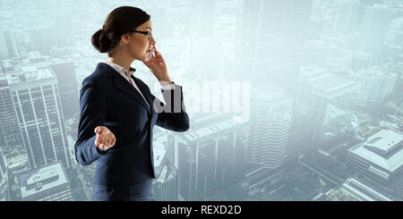 Elegant businesswoman on building roof talking mobile phone. 3d rendering Stock Photo