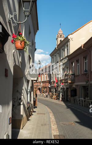 Vilnius, Lithuania - May 28, 2018: Beautiful narrow street with outdoor cafes in Vilnius old city, Lithuania Stock Photo