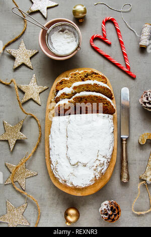 Christmas decorations and stollen cake flat lay. Traditional Dresdner christ pastry top view Stock Photo