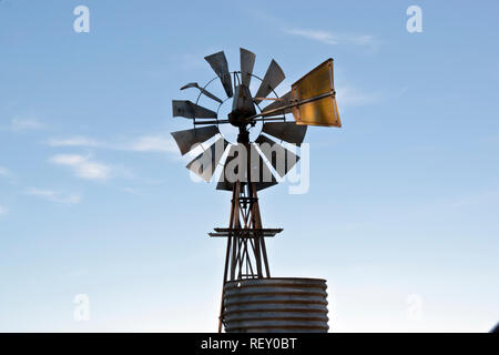 the wind mill is used to pump water to the animals Stock Photo