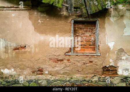 window of an abandoned house covered with bricks Stock Photo