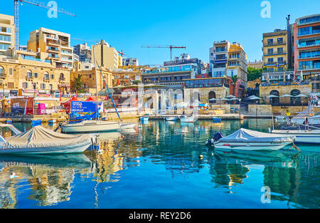 ST JULIANS, MALTA - JUNE 20, 2018: The popular tourist resort offers many place for rest and different attraction, here holidaymakers will find nice c Stock Photo