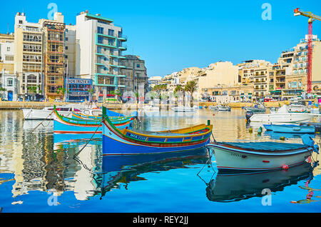 ST JULIANS, MALTA - JUNE 20, 2018: Resort boats many nice places for rest, Spinola Bay is nice location to visit coastal cafe, walk along the harbor a Stock Photo