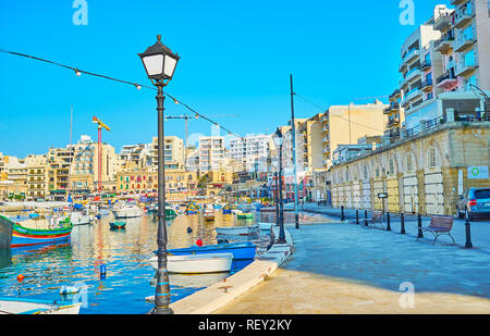 ST JULIANS, MALTA - JUNE 20, 2018: The coastal neighborhoods of St Julian's are quiet and calm place in the early morning, it's pleasure to walk here  Stock Photo