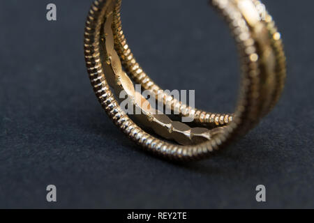 Detail of golden wedding ring on black background Stock Photo