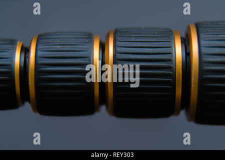 Black thread with golden edges on dark background and space for text Stock Photo