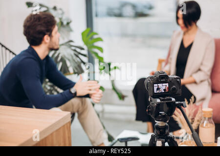 camera shooting the woman and man's conversation Stock Photo