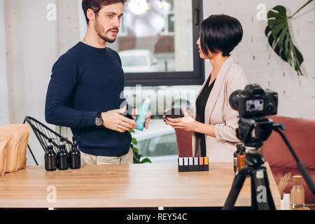 businessman is showing his goods to a anchorwoman Stock Photo