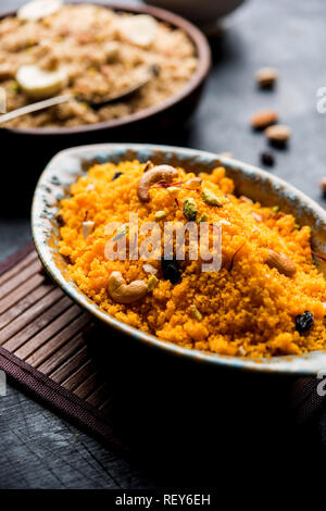 Badaam kesar shira / Sheera or almond saffron halwa, popular Indian dessert served in a bowl. selective focus Stock Photo