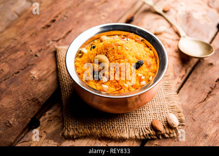Badaam kesar shira / Sheera or almond saffron halwa, popular Indian dessert served in a bowl. selective focus Stock Photo