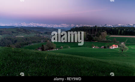 Wonderfull sunset in the Swiss alps. Countryside of bern. purple sky over the scene Stock Photo