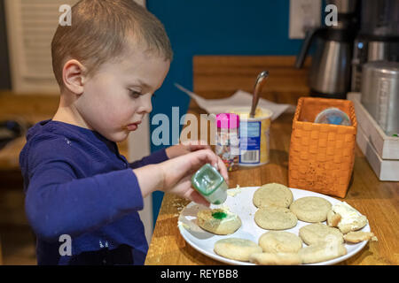 Denver, Colorado - Four-uear-old Adam Hjermstad Jr. makes Christmas cookies in his family's kitchen. Stock Photo