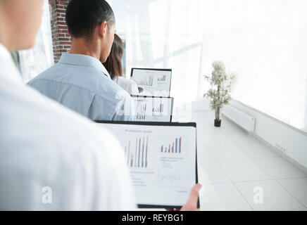 rear view.business colleagues holding folders with financial data Stock Photo