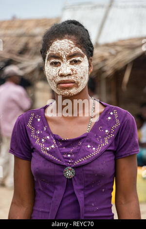 Andavadoaka, Madagascar - January 13th, 2019: Portrait of a local young Malagasy woman with her face painted as a Sakalava-Vezo tradition in Andavadoa