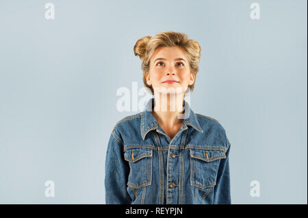 Young very beautiful strongly emotional girl shows different gestures on an isolated blue background. Concept of human emotions Stock Photo