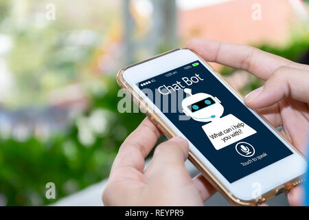 artificial intelligence,AI chat bot concept. Hands holding mobile phone on blurred abstract background. chatbot answering questions online, robot assi Stock Photo