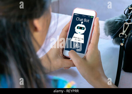 artificial intelligence,AI chat bot concept. Hands holding mobile phone on blurred abstract background. chatbot answering questions online, robot assi Stock Photo
