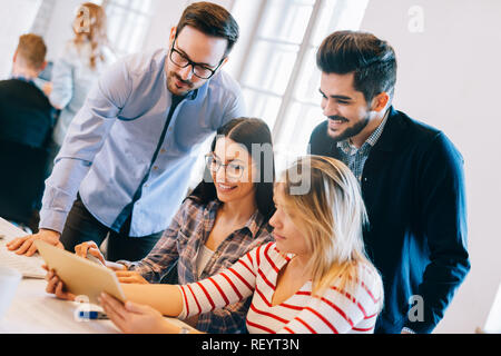 Group of young architects using digital tablet Stock Photo