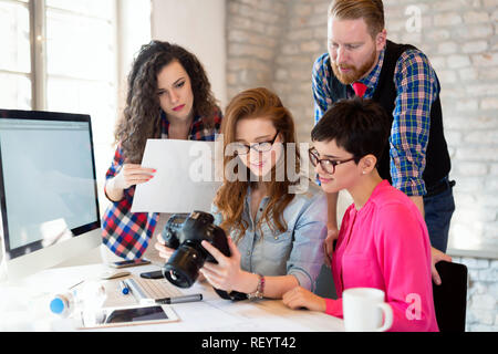 Picture of young attractive designers looking at camera Stock Photo