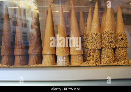 A pile of waffle cones for ice cream ready to be filled with ice cream in a cafe, restaurant. Showcase of a cafe, a pastry shop, a restaurant . Stock Photo