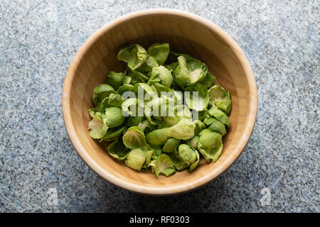 Food, Brussels sprouts, Studio Shot . Brussels sprouts leaves in a round bowl of wood . Stock Photo