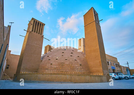 Preserved medieval mudbrick yakhchal (ice chamber) with tall adobe badgirs (windcatchers) in old neighborhood of Yazd, Iran. Stock Photo