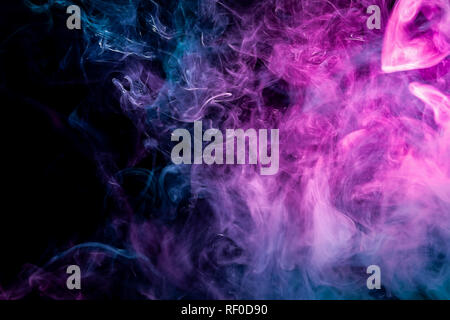 Dense multicolored smoke of   pink and blue colors on a black isolated background. Background of smoke vape Stock Photo