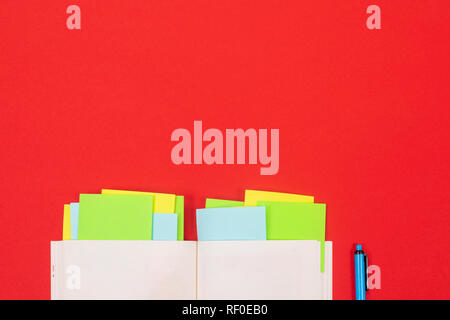 bright stickers, Notepad and pen isolated on red background Stock Photo