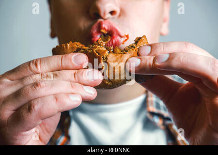 close up burger in mouth of man Stock Photo