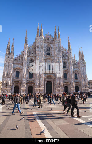 Milan, Italy - January 19, 2018: Tourists and ordinary people walk on Piazza del Duomo or Cathedral Square near Milan Cathedral Stock Photo