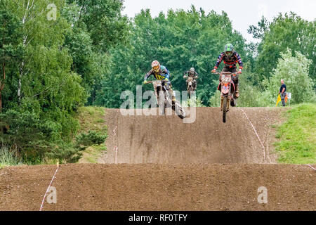 Riders on 250 cc motocross bikes jumping at Deutsche Meisterschaft at the motocross circuit Am Österreicher Stock Photo