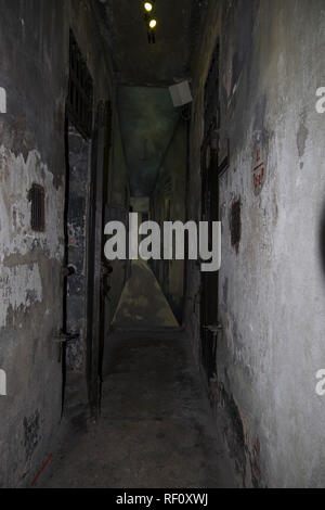Looking down a hallway of cells at the Hanoi Hilton prison museum in Hanoi, Vietnam. Stock Photo