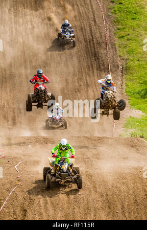 Riders on motocross quads jumping at Deutsche Meisterschaft at the motocross circuit Am Österreicher Stock Photo