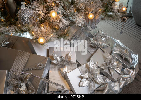 Silver presents under Christmas tree Stock Photo