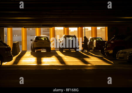 Woman With Early Morning Light Streaming Into Parking Garage, Boston, USA Stock Photo
