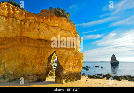 Yellow-golden cliff rocks at the Camilo beach, Praia do Camilo, Lagos, Algarve, Portugal Stock Photo