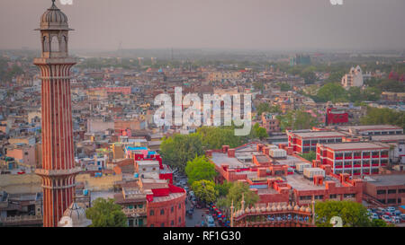 View of old part of New Delhi, busy market bazaar street and the Red Fort from a minaret at Jama Masjid mosque. Stock Photo