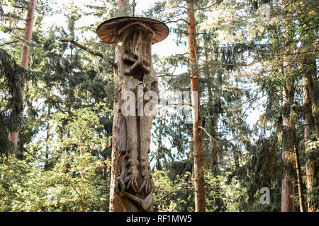 JUODKRANTE, LITHUANIA - AUGUST, 2018: Traditional Lithuanian Raganu kalnas wood carving art sculptures of folk musicians in public nature park in Juod Stock Photo