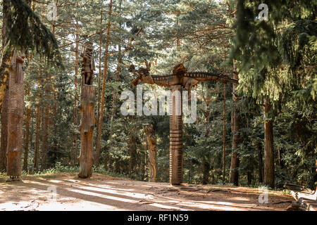 JUODKRANTE, LITHUANIA - AUGUST, 2018: Traditional Lithuanian Raganu kalnas wood carving art sculptures of folk musicians in public nature park in Juod Stock Photo