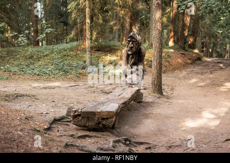 JUODKRANTE, LITHUANIA - AUGUST, 2018: Traditional Lithuanian Raganu kalnas wood carving art sculptures of folk musicians in public nature park in Juod Stock Photo