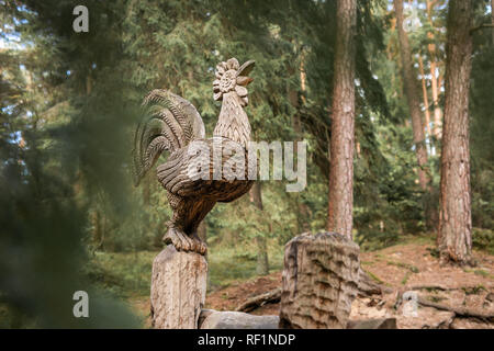 JUODKRANTE, LITHUANIA - AUGUST, 2018: Traditional Lithuanian Raganu kalnas wood carving art sculptures of folk musicians in public nature park in Juod Stock Photo