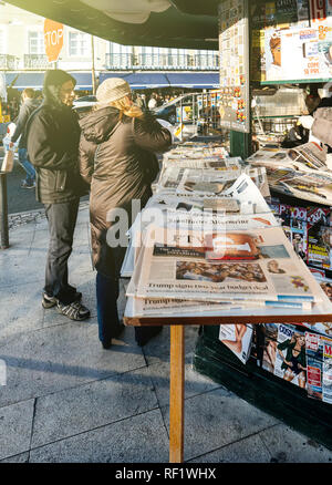 LISBON, PORTUGAL - FEB 10, 2018: People shopping for international newspapers on kiosk in central Lisbon Stock Photo