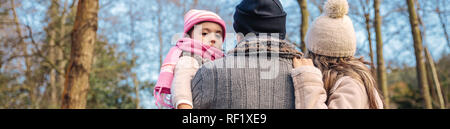 Couple with her little daughter enjoying of forest landscape Stock Photo