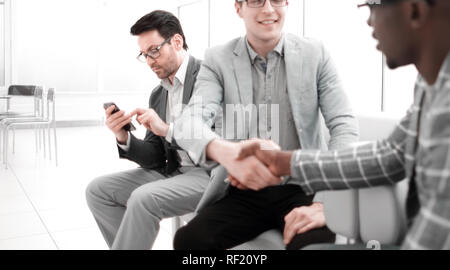 young people shaking hands in the lobby of a modern office Stock Photo