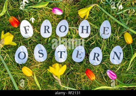 Happy easter - German text on eggs with flowers Stock Photo
