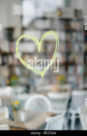 Painted heart on windowpane at a cafe Stock Photo