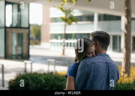 Netherlands, Maastricht, affectionate young couple hugging in the city