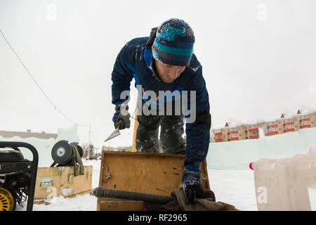Portrait of a worker at an assembly site of an ice town in winter overalls Stock Photo