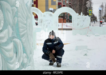 Portrait of a worker at an assembly site of an ice town in winter overalls Stock Photo