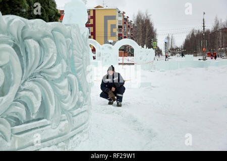 Portrait of a worker at an assembly site of an ice town in winter overalls Stock Photo